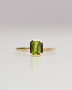 The octagon-shaped peridot on this ring is both eye-catching and elegantly simplistic. It is the perfect way to celebrate a special August birthday or simply adorn oneself with its stunning light green hue. Unique Peridot Ring, Green Peridot Ring, August Birth Stone Ring, Peridot Ring Engagement, Peridot Wedding Ring, Peridot Ring Gold, Peridot Rings, Peridot Engagement Rings, August Birthstone Ring