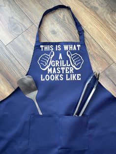 this is what a grillmaster looks like apron and utensils are in front of it