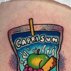 an image of a tattoo on the back of a woman's shoulder with a drink and fruit in it