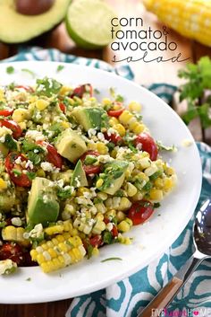 corn and avocado salad on a white plate