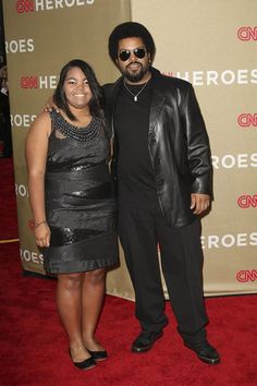 a man and woman standing on a red carpet