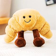 a yellow stuffed animal sitting on top of a bed