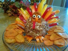 a turkey made out of crackers sitting on top of a glass plate