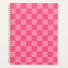 a notebook with pink squares on it