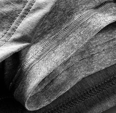 a black and white photo of the back pocket of a pair of jeans with stitching on them