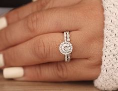 a woman's hand with a diamond ring on it