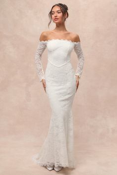 a woman in a white wedding dress with long sleeves and an off the shoulder top