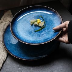 a person holding a plate with food on it