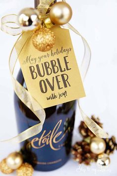 a bottle of wine with a tag on it that says, may your holidays bubble over with joy