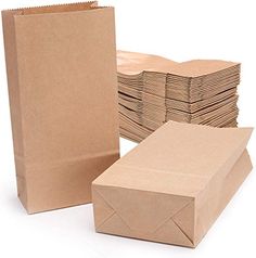 brown paper bags are stacked on top of each other and ready to be used as envelopes