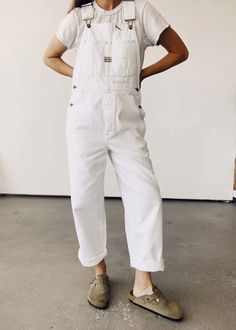 Hey gang's minor overalls take inspiration from vintage overalls and are crafted from 100% white cotton denim. the minor overalls feature a unisex design green accent stitching a carpenter loop and pocket triangle needle stitch seams and an oversized fit.    model is wearing a size 1 we recommend sizing down if you prefer a more fitted look    - sz 1 / s  - sz 2 / m  - sz 3 / l    100% cotton    machine wash cold tumble dry low White Jean Overalls, Trendy High-rise Cotton Overalls, Chic High-rise Cotton Overalls, Linen Overalls Outfit, White Carhartt Overalls, White Denim Overalls