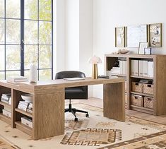 a wooden desk sitting in front of a window next to a book shelf filled with books