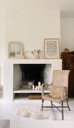 a living room filled with furniture and a fire place covered in candles next to a fireplace