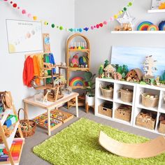 a child's playroom with toys and bookshelves on the wall, rugs in front of it