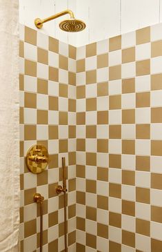 the shower head is gold and white checkered