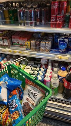 a grocery cart filled with food and drinks