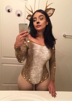 a woman is taking a selfie in the mirror with deer makeup on her face