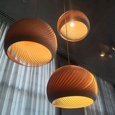 three circular lights hanging from the ceiling in a room