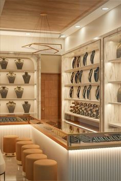 the interior of a jewelry store with shelves and stools