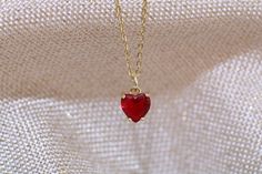 Gold filled red ruby heart stud charm pendant necklace. with matching earring option. Dainty minimalistic red heart tiny charm necklace High quality 18k gold plated  With adjustable chain - Length option of 14'' to 16'' ,or 16'' to 18''  chain. Dainty minimalistic pendant charm. Great as a gift ,or for yourself for that special occasion! Any questions feel free to ask! Thanks for supporting a small family run business! Comes packaged in a beautiful box ready to gift! Red Heart Gold Necklace, Red Ruby Jewelry Gift For Her, Dainty Birthstone Jewelry For Valentine's Day, Red Heart-shaped Birthstone Jewelry, Tiny Heart Pendant Jewelry For Valentine's Day, Ruby Clavicle Chain Jewelry Gift, Ruby Clavicle Chain Jewelry As Gift, Elegant Red Jewelry With Heart Charm, Dainty Red Birthstone Necklace