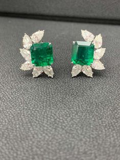 For Sale on 1stDibs - A simple and fashionable pair of Certified earrings showcasing a cluster of pear shape diamonds surrounding emerald-cut Emerald halfway, set in a beautiful Luxury Emerald-cut Diamond Earrings For Formal Occasions, Luxury Emerald Cut Diamond Earrings For Formal Occasions, Green Emerald Cut Diamond Earrings For Formal Events, Emerald Cut Green Diamond Earrings For Formal Events, Green Emerald Cut Diamond Earrings For Formal Occasions, Formal Green Emerald Cut Diamond Earrings, Emerald Cut Diamond Earrings For Formal Occasions, Formal Baguette Cut Emerald Earrings, Formal Baguette-cut Emerald Earrings