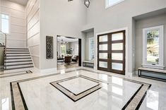 a large foyer with marble floors and white walls