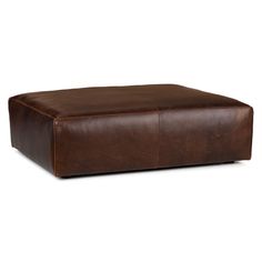 a brown leather ottoman sitting on top of a white floor