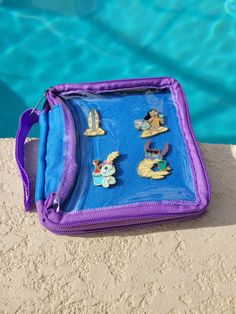 a blue and purple bag sitting next to a swimming pool