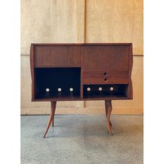 a wooden cabinet with three drawers and four knobs