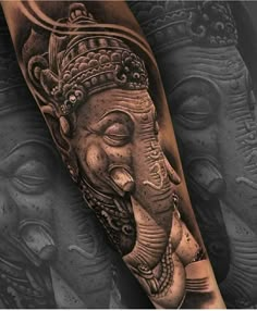 an elephant with a crown on its head is shown in this black and grey tattoo