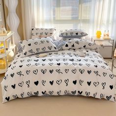 a bed with black and white hearts on it