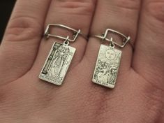 "Copy and paste into your browser, get 15% off ➔ https://bit.ly/VD15OFF Why not get a statement dangle ring for your jewelry collection? Offering all 22 tarot cards from The Major Arcana, the choice is yours with this tarot card ring. DETAILS: -One Ring -Sterling Silver -18mm x 10mm tarot card -Stainless Steel Adjustable US Size 6-11 Ring -1mm Thick Stainless Steel You will receive one stainless steel adjustable tarot card ring. **Every item is handmade, this means that each will be unique and may not look EXACTLY like the picture, but it will look very similar ➡ORDER PROBLEMS If there are any problems with your order please contact me, my goal is for you to be happy with your products and I will do what I can to help! ➡BULK ORDERS I gladly make bulk orders! For every bulk order of 15+, th Adjustable Wire Bracelet, Mystic Jewelry, Goth Friends, Card Ring, Dangle Ring, Jewelry Goth, The Major Arcana, Friendship Ring, Mystical Jewelry