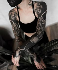 a woman with tattoos on her arm and arms