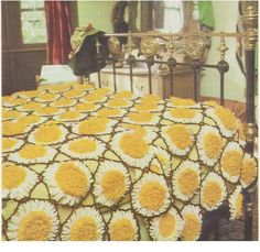 an image of a bed with yellow and white crocheted bedspreads