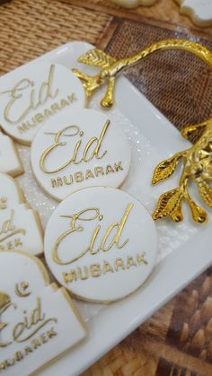 white and gold decorated cookies on a plate