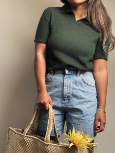 a woman holding a bag with a sunflower in it