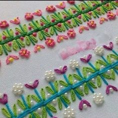 two rows of stitching with flowers on them