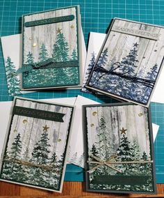 four cards with trees on them sitting on top of a table