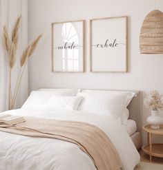 a bedroom with two paintings on the wall above the bed