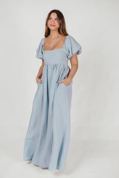 Join us in welcoming the *breathtaking* Candace Maxi Dress to the Worth Collective repertoire - we know you're going to love her! This pastel-hued, 100% linen dress is the epitome of elegance and luxury. Its beautiful neckline frames your decolletage, while the gently puffed sleeves and full skirt accent this gown's exquisite craftmanship. It's the perfect choice for this season's weddings, photo shoots, and other special events! FIT: Runs true to size. Empire waist and smocked bodice will accom Fitted Linen Maxi Dress For Spring, Blue Fitted Linen Midi Dress, Chic Blue Linen Maxi Dress, Fitted Blue Linen Dress, Fitted Blue Linen Dress For Daywear, Blue Linen Maxi Dress With Short Sleeves, Blue Linen Short Sleeve Maxi Dress, Blue Maxi Linen Dress, Blue Linen Maxi Dress