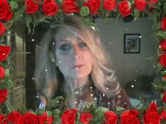 a woman with long blonde hair and blue eyes is surrounded by red roses in a frame