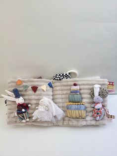 a group of stuffed animals sitting on top of a blanket