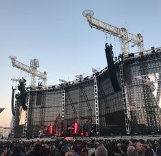 the stage is set up for a concert with lots of people standing around and looking at it