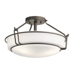 a semi flush ceiling light with an oval glass shade