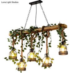 four lights hanging from a wooden beam with ivy growing on it