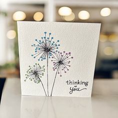 a card with a dandelion design on it