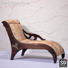 a small wooden chair sitting on top of a white table next to a beige wall