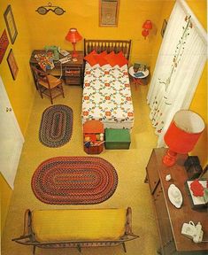 an aerial view of a bedroom with yellow walls and carpeted flooring, including a bed