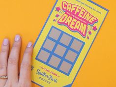 a person's hand on top of a sticker with the words caffeine dream