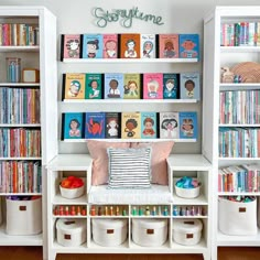 a white bookcase filled with lots of books next to a wall full of children's books